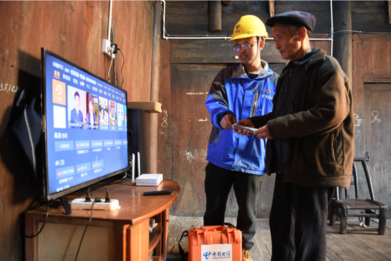 电信装维人员为村民安装调测宽带和IPTV