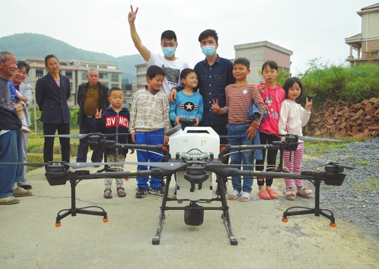 4月17日,邵阳隆回县,黄隆龙(白衣)、牟建国(蓝衣)与小男孩和他的朋友一起合影。图/受访者提供