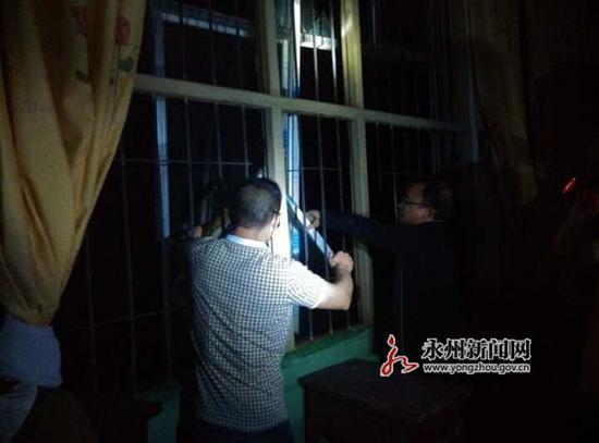 道县四马桥中学教师在摸黑拆除被龙卷风损坏的教室玻璃
