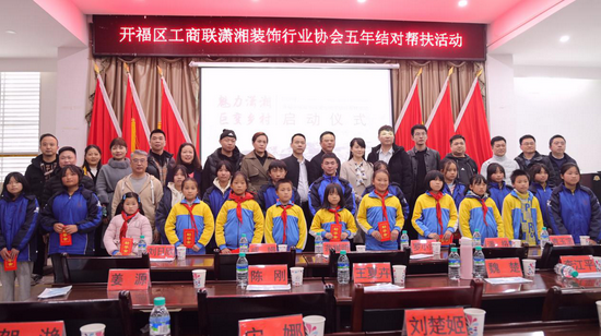 (开福区工商联潇湘装饰行业协会爱心企业人士与受资助学生合影)
