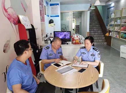 凌建明(中)正在调研走访养犬管理登记办证点