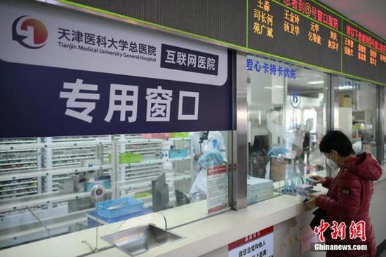  3月4日，天津医科大学总医院，一名患者在药房取药。 中新社记者 佟郁 摄