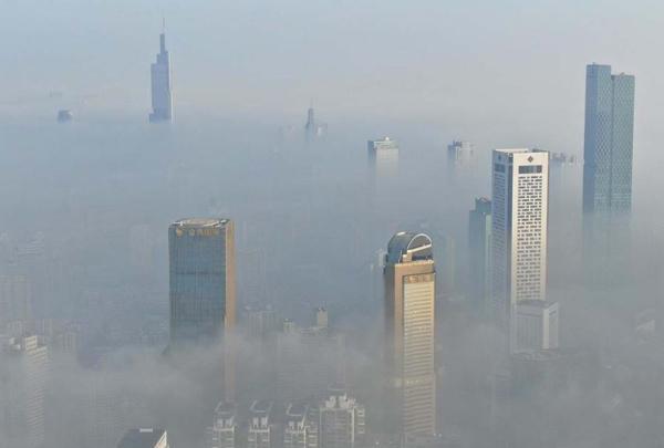 11月27日,江苏省南京市,城市中心楼宇在大雾中若隐若现。视觉中国 图