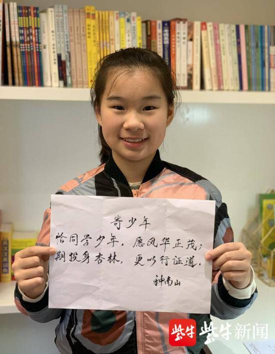 赵李慕子拿着钟南山爷爷亲笔题的诗句。