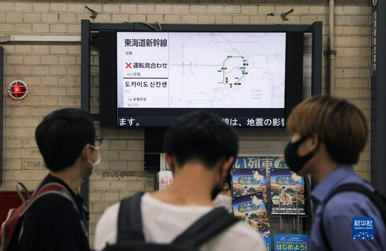 10月7日,在日本东京,人们关注一个车站前屏幕上的信息,上面显示新干线线路暂停运营。据日本气象厅消息,日本千叶县西北部7日晚发生6.1级地震,东京地区震感强烈。新华社记者杜潇逸摄