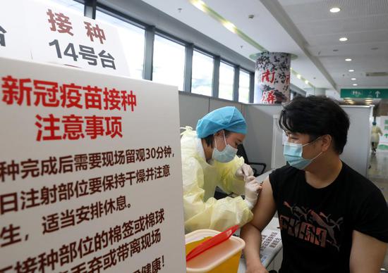 5月18日,在上海市徐汇区凯旋南路接种点,护士为市民接种腺病毒载体疫苗。(新华社记者刘颖摄)