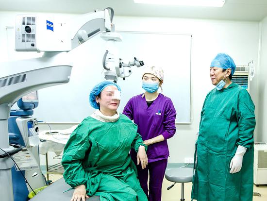 40多岁、高度近视的姜女士(左)对张雷(右)为其做的多焦点人工晶状体植入手术十分满意。