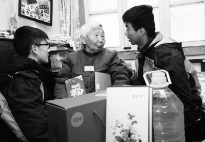 昨天,志愿者在杨翠英家中和老人交流。 本报记者 崔晓摄