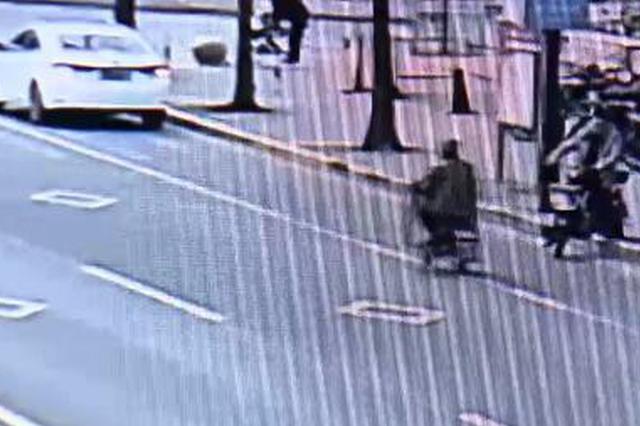 骑电瓶车逆行闯红灯被警车拦停 男子拿石头砸警车