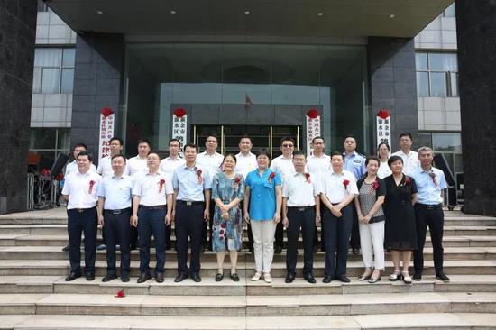 出席揭牌仪式的市直有关单位负责人、渝水区领导与镇班子成员在办公大楼前合影。