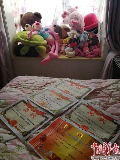 赵女士向记者展示女儿小静获得的荣誉证书。中国青年报·中青在线记者 雷宇/摄