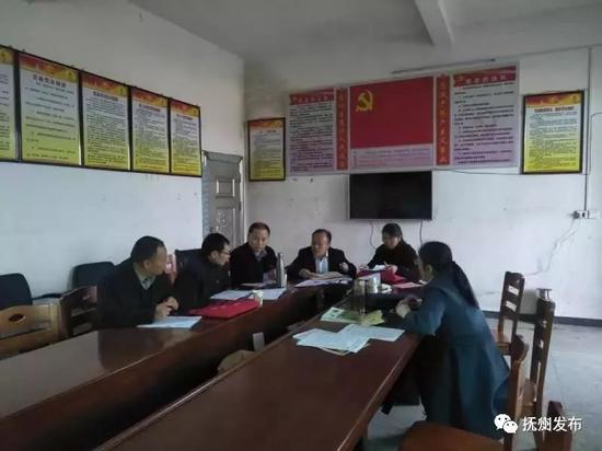 ▲缪连英生前与驻村帮扶干部一起研究村里的脱贫攻坚工作
