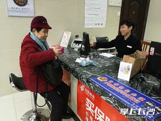 周娭毑走到湖南邮政八一支行,缴了300元电费。 长沙晚报记者 伍玲 摄