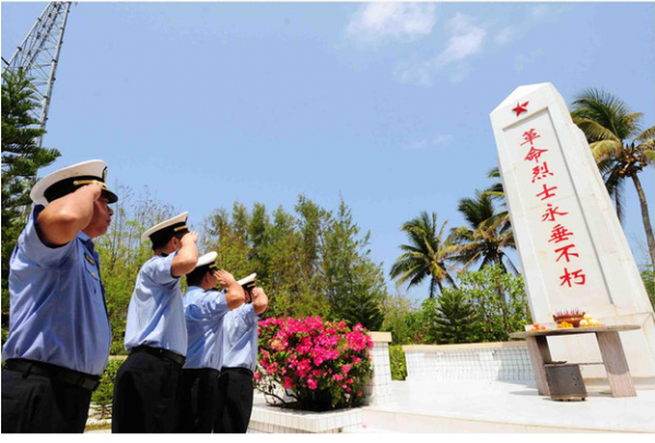 中国海监人员向琛航岛上“永乐群岛自卫反击作战烈士陵园”默哀。(新华社发)