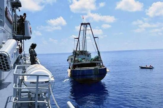印尼军舰（左）2016年6月在纳土纳群岛附近海域检查中国渔船