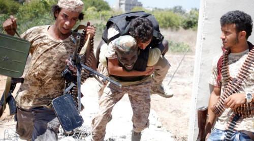 2016年7月31日，利比亚团结政府部队在苏尔特与伊斯兰国武装分子作战。政府军的一名战士掩护另外一名战士背着伤员撤离