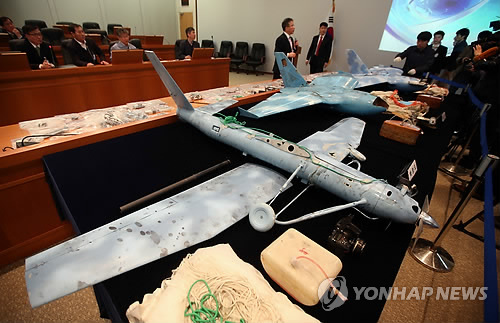 图说: 2014年4月11日,位于大田的韩国国防科学研究所工作人员向记者展示在韩国发现的无人机及其内部设备。韩国初步认定在韩坠毁无人机来自朝鲜。 新华社/纽西斯通讯社