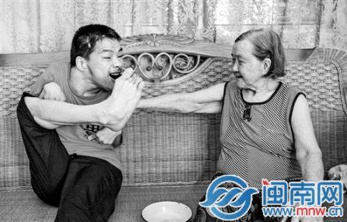 陈海波学会用脚吃饭，阿嬷开心地搭着他的肩膀微笑