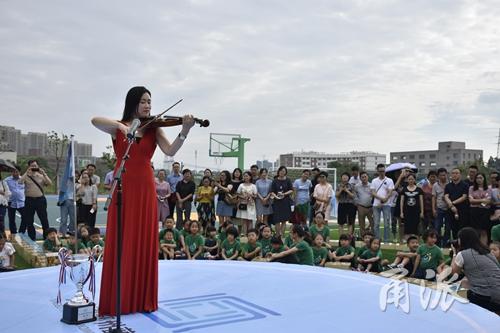 (老师为同学们拉起小提琴《我长大了》。)