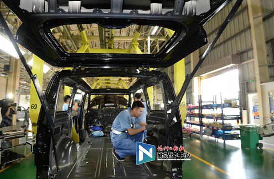 福建奔驰生产车间内,工人正在忙碌。叶义斌/摄