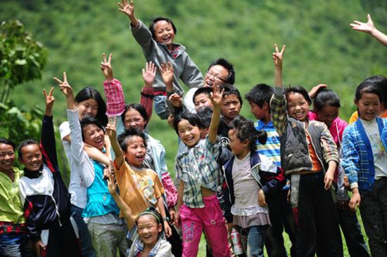 2012年7月,贵州华农大石希望小学,研究生支教团志愿者和孩子们一起。来源:中国文明网