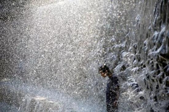 △8月1日，在日本东京，儿童在公园里的喷泉中纳凉。