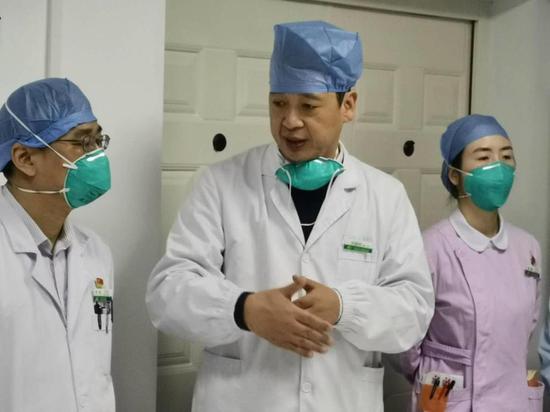 劉智明(中)在醫院辦公室安排部署工作。(注:怕大家聽不清,劉智明專門摘下口罩)