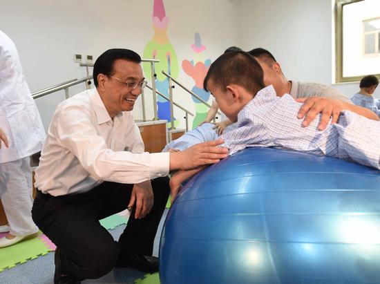 2014年5月30日，李克强在八一儿童医院看望孤残儿童。（资料图）