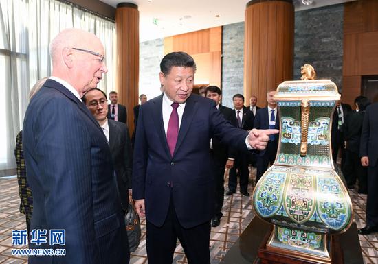 1月17日，国家主席习近平在瑞士达沃斯会见世界经济论坛主席施瓦布。这是习近平向施瓦布介绍中华人民共和国赠送给世界经济论坛的四面方尊。新华社记者 饶爱民 摄