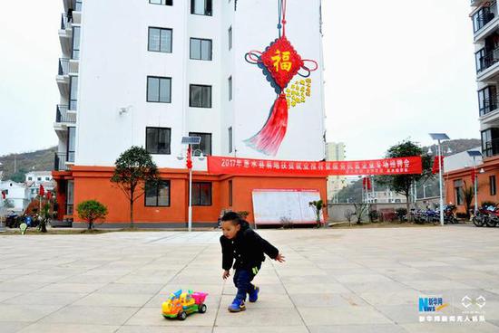 　　为贵州惠水县经济技术开发区易地扶贫搬迁安置点明田新村内，一名小朋友在广场上玩耍。