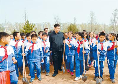 　　图为：2016年4月5日，习近平来到北京市大兴区西红门镇参加首都义务植树活动。这是植树活动结束时习近平同少先队员在一起。