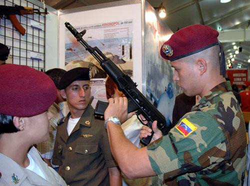 资料图片：在委内瑞拉首都加拉加斯举行的军事博览会上，一名委内瑞拉军人在俄罗斯国防出口公司的展台观看AK-103步枪。新华社记者张笑然摄