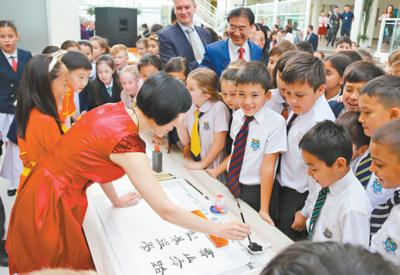6月1日，中国驻阿拉木图总领馆举办中国文化进校园活动，学生们对中国书法艺术兴趣盎然。 本报记者 周翰博摄
