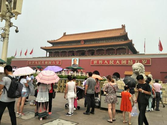 7月1日，北京天气闷热，游客打伞防晒。（泉源：微博） 