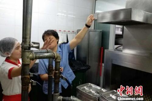 北京市食药监局执法人员对海底捞劲松店进行检查。陈琳 摄