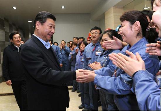 2013年12月28日，中共中央总书记、国家主席、中央军委主席习近平在北京看望一线职工和老年群众。这是习近平与北京京桥热电有限公司当班职工一一握手。新华社记者 饶爱民 / 摄