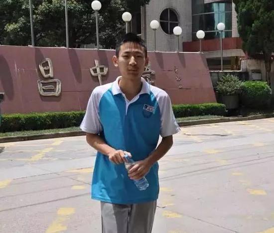 图:郑烨高考前在校门口留影。来源:浙江在线丽水频道。