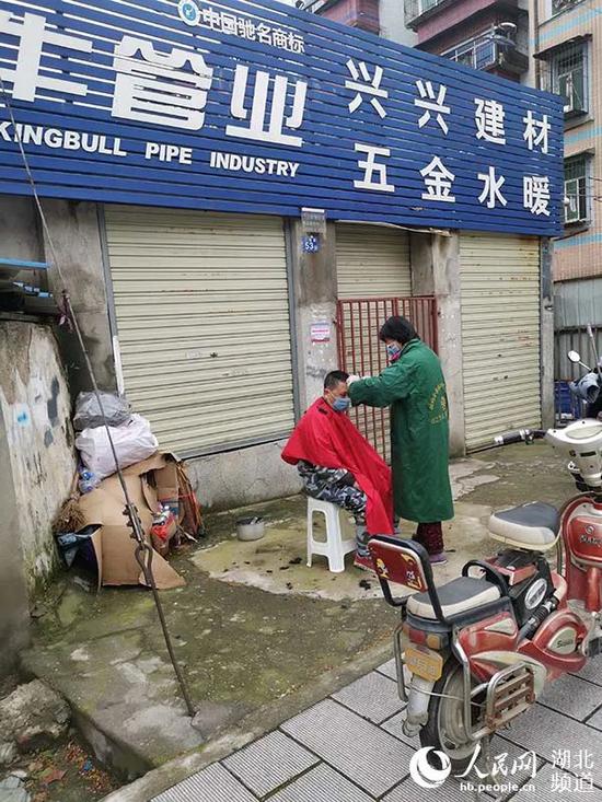 市民在路边理发。(周雯 摄)