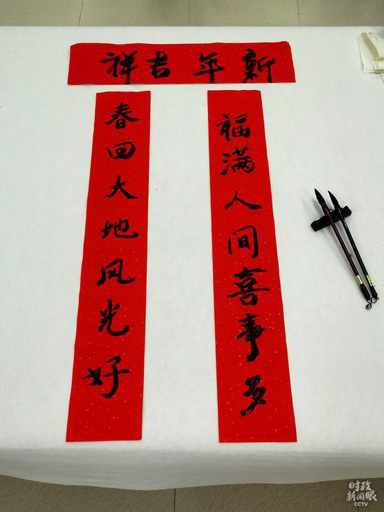 △84岁的社区住民戴世伦老老师,曾在贵州广播电视大学任教。这是他写的对联。(总台央视记者彭汉明、姚瑶拍摄)