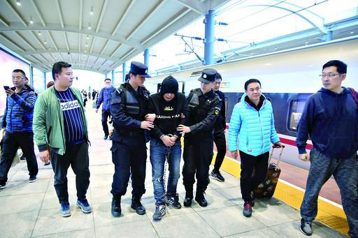 11月6日,鹤壁东站站台上,李某在民警的押解下回到鹤壁。