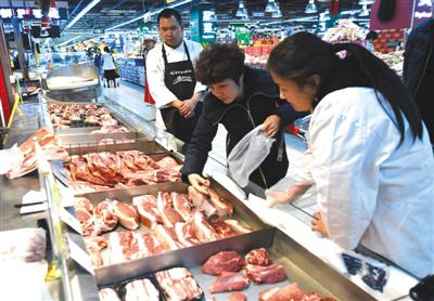 昨日,市民在双井家乐福选购黑猪肉。在这里包装精分五花肉条62.80元/斤,包装优质带皮前腿40.80元/斤。 新京报记者 吴宁 摄
