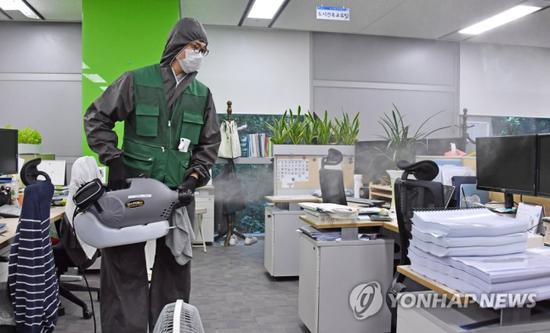 工作人员对办公室消毒(韩联社)