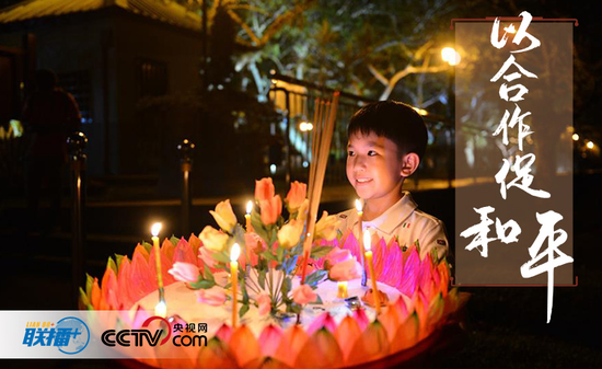 图为:一名男孩在文莱斯里巴加湾市参加水灯节活动,祈求幸福吉祥