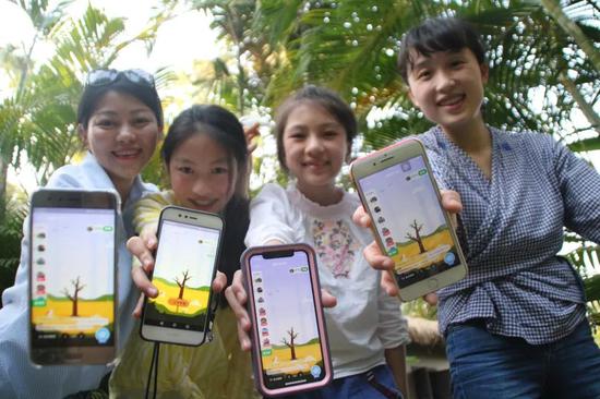 2月20日，来自重庆的王小姐一家展示她们手机里的蚂蚁森林合种页面。