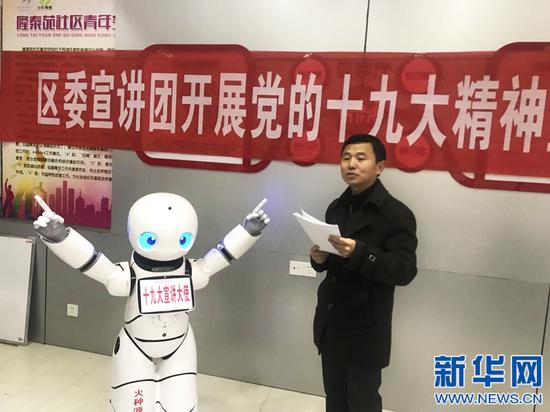 西湖区宣传部常务副部长李刚和机器人“优友”一起宣讲党的十九大精神。