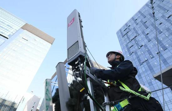 4月4日,韩国首尔一名技术人员在检查5G天线。(新华社/法新)