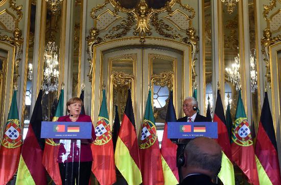   ▲5月31日，在葡萄牙访问的默克尔在新闻发布会上表示，美国对欧盟钢铝产品征收高关税违背世贸组织规则。 图/新华社