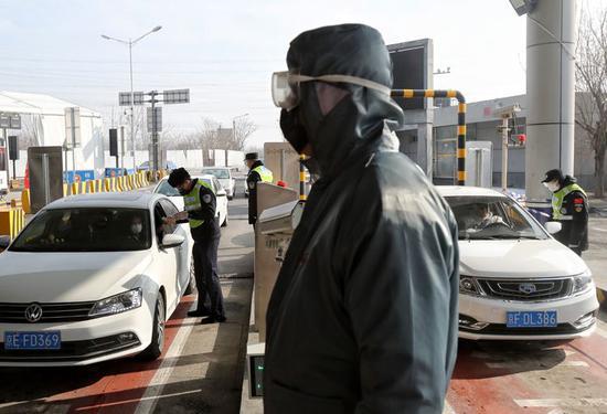 通燕高速白庙进京检查站，民警对每辆进京车辆都进行人员信息核实和体温测量。