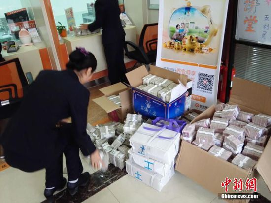 11月19日，山东省日照市日照银行内，工作人员在清点40万元零钱。