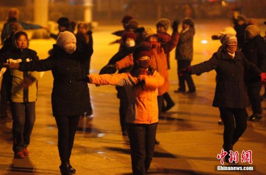 东北大妈雾霾天全副武装跳广场舞。图片来源:视觉中国